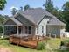 Backyard featuring a wooden deck with hot tub and a well-maintained yard surrounded by lush trees for privacy at 4237 Island Fox Ln, Denver, NC 28037