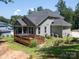Beautiful backyard featuring a wooden deck with a hot tub and lush greenery, perfect for outdoor enjoyment at 4237 Island Fox Ln, Denver, NC 28037