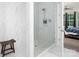 Modern bathroom features a glass shower with white marble tiling and an adjacent bedroom at 4237 Island Fox Ln, Denver, NC 28037