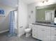 Bright bathroom features a vanity with granite countertop, white cabinets, and a shower-tub combination at 4237 Island Fox Ln, Denver, NC 28037