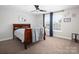 Bedroom with a wooden sleigh bed, ceiling fan, and natural light from the windows at 4237 Island Fox Ln, Denver, NC 28037