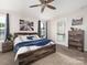Comfortable bedroom with a wooden bed frame, ceiling fan, and natural light at 4237 Island Fox Ln, Denver, NC 28037