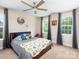 Bright bedroom with a ceiling fan, two large windows, and stylish wall decor at 4237 Island Fox Ln, Denver, NC 28037