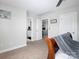 Bedroom featuring a neutral color scheme with access to an ensuite bathroom and living area at 4237 Island Fox Ln, Denver, NC 28037