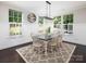 Bright dining room featuring large windows, white wainscoting, and a stylish light fixture at 4237 Island Fox Ln, Denver, NC 28037