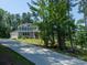 Charming two-story home with gray siding, dormer windows, attached garage, and a long driveway at 4237 Island Fox Ln, Denver, NC 28037