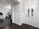 Bright foyer featuring dark wood floors, wainscoting, and access to a home gym at 4237 Island Fox Ln, Denver, NC 28037