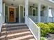 Inviting front porch with brick steps, white railings, and a decorative front door at 4237 Island Fox Ln, Denver, NC 28037