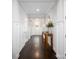 Inviting hallway with dark hardwood floors, white wainscoting, and a decorative console table at 4237 Island Fox Ln, Denver, NC 28037