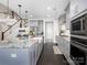 Modern kitchen with white countertops, stainless steel appliances, and an open staircase at 4237 Island Fox Ln, Denver, NC 28037