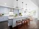 Modern kitchen featuring light gray cabinets, a large island, and stainless steel appliances at 4237 Island Fox Ln, Denver, NC 28037