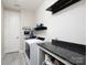 Neat laundry room with granite countertop, modern washer/dryer, and stylish decorations at 4237 Island Fox Ln, Denver, NC 28037