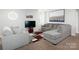 Cozy living room with gray sofas, patterned rug, and a TV for entertainment at 4237 Island Fox Ln, Denver, NC 28037