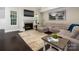 Cozy living room with a fireplace, large sofa, and dark hardwood floors at 4237 Island Fox Ln, Denver, NC 28037
