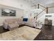 Spacious living room featuring a large sectional sofa, staircase, and hardwood floors at 4237 Island Fox Ln, Denver, NC 28037