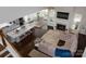 Open-concept living area showcasing a spacious kitchen, dining area, and living room with fireplace and hardwood floors at 4237 Island Fox Ln, Denver, NC 28037