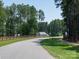 Picturesque streetscape featuring wooden fences and a lush tree lined neighborhood at 4237 Island Fox Ln, Denver, NC 28037
