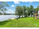 Expansive backyard with lush lawn leading to the lake, featuring a charming gazebo and private dock at 441 Wildlife Club Ln, Taylorsville, NC 28681
