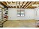 Unfinished basement area featuring a window for natural light and ample shelving for storage at 441 Wildlife Club Ln, Taylorsville, NC 28681