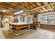 Unfinished basement with exposed ceiling, large workbench and lots of storage space at 441 Wildlife Club Ln, Taylorsville, NC 28681