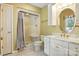 Bright bathroom featuring a shower with curtain, white vanity, and a round mirror at 441 Wildlife Club Ln, Taylorsville, NC 28681