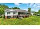 Exterior view of the home with a sunroom, and a large yard perfect for outdoor activities at 441 Wildlife Club Ln, Taylorsville, NC 28681