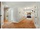 Inviting foyer featuring hardwood floors, elegant wallpaper, and a glimpse of a bright, tiled bathroom space at 441 Wildlife Club Ln, Taylorsville, NC 28681