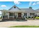 Welcoming front entrance with covered porch, brick steps, decorative sidelights, and meticulous landscaping around walkway at 441 Wildlife Club Ln, Taylorsville, NC 28681