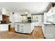 A kitchen featuring a large island, white cabinetry, black countertops and stainless steel appliances at 441 Wildlife Club Ln, Taylorsville, NC 28681