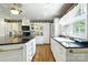 Bright kitchen featuring a large island with black countertops and stainless steel appliances at 441 Wildlife Club Ln, Taylorsville, NC 28681
