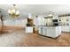 Bright kitchen featuring a large island with black countertops and stainless steel appliances at 441 Wildlife Club Ln, Taylorsville, NC 28681