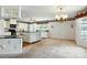 Open kitchen featuring white cabinetry, pendant lighting, and granite countertops, seamlessly flowing into living space at 441 Wildlife Club Ln, Taylorsville, NC 28681