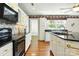 The kitchen area features white cabinets, black countertops, and stainless steel appliances at 441 Wildlife Club Ln, Taylorsville, NC 28681