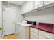 Functional laundry room featuring a washer, dryer, storage cabinets, and folding counter at 441 Wildlife Club Ln, Taylorsville, NC 28681