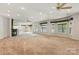 Bright and spacious living room with neutral carpet, recessed lights, fireplace, and adjacent dining and kitchen areas at 441 Wildlife Club Ln, Taylorsville, NC 28681