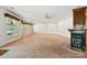 Expansive living area showcasing neutral carpet, recessed lights, ample natural light, and a cozy fireplace at 441 Wildlife Club Ln, Taylorsville, NC 28681
