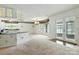 Bright and open living space connected to kitchen, featuring neutral carpet and natural light at 441 Wildlife Club Ln, Taylorsville, NC 28681