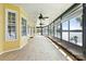 Lake view through the windows of the bright and airy enclosed sunroom with ceiling fans at 441 Wildlife Club Ln, Taylorsville, NC 28681