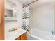 Functional bathroom features a vanity sink, mirror, and tub with shower, providing a simple space at 5239 Lineberger Rd, Stanley, NC 28164