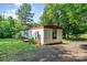 A cozy home nestled among lush green trees offers a serene and private setting at 5239 Lineberger Rd, Stanley, NC 28164