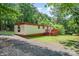 Charming single-story home with gravel driveway and a small deck at 5239 Lineberger Rd, Stanley, NC 28164
