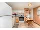 Functional kitchen featuring essential appliances and wood paneled walls at 5239 Lineberger Rd, Stanley, NC 28164