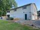 Back exterior featuring a walkout basement, an exterior door, and stone detailing at 5570 George Henry Dr, Hickory, NC 28602