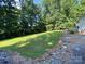 Spacious backyard with rock accents, and mature trees at 5570 George Henry Dr, Hickory, NC 28602
