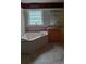 Bright bathroom with a corner tub, neutral tones, and ample cabinet space at 5570 George Henry Dr, Hickory, NC 28602
