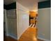Hallway view of the kitchen, featuring hardwood floors and a closet at 5570 George Henry Dr, Hickory, NC 28602