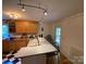 Well-lit kitchen with a breakfast bar and black-and-white checkered floors at 5570 George Henry Dr, Hickory, NC 28602