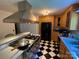 Well-equipped kitchen with updated appliances, wooden cabinets and checkered flooring at 5570 George Henry Dr, Hickory, NC 28602