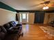 Comfortable living room features hardwood floors and a large leather sofa at 5570 George Henry Dr, Hickory, NC 28602