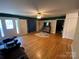Spacious living room featuring hardwood floors, a ceiling fan and natural light at 5570 George Henry Dr, Hickory, NC 28602